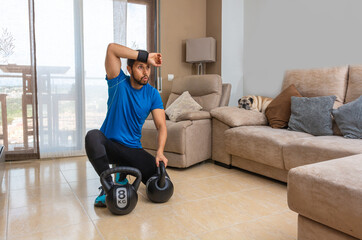 Latin man performing a cross fit workout at home