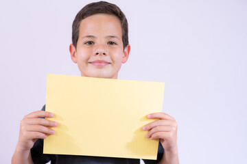 Smiling boy portrait holding blank paper. Isolated on white background