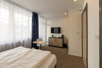 Fototapeta na wymiar Bedroom interior in hotel apartment in the morning