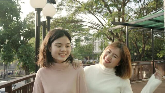 Young happy asian pretty girls couple friend travel walk in the city street relax talk with smile face. Close Up portrait joyful attractive young women, Outdoor holiday vacation activity concept.
