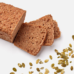 sliced rye bread on a white plate with pumpkin seeds