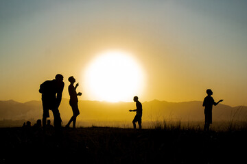 Fototapeta na wymiar group of people on sunset