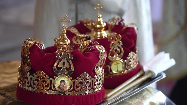 Golden religious crowns in the church. Wedding. Traditional symbols of Christianity. God, faith, marriage