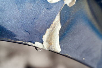 Damaged car bumper with a drop of water