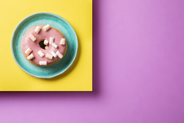 Pink doughnut on a saucer