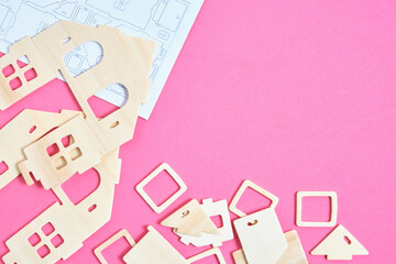 Details and instructions, constructor of prefabricated wooden orphanage on pink background.