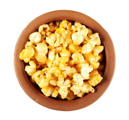 Spicy pepper flavored popcorn in clay pot isolated on white background, top view