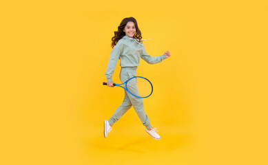 Fototapeta na wymiar healthy and active lifestyle. sport success. happy childhood. kid jump with racket.