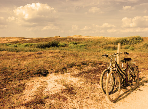 Two bicycles in countryside. Brittany, France. The concept of romance, love and simple everyday life. Retro aged photo.