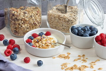 healthy breakfast, spelt flakes and cereals with yogurt and berries 