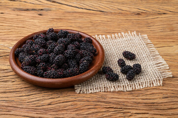 Blackberries in a plate over wooden table