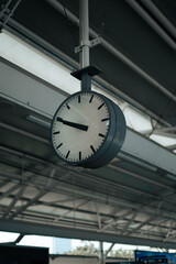 a large hanging clock located at the station