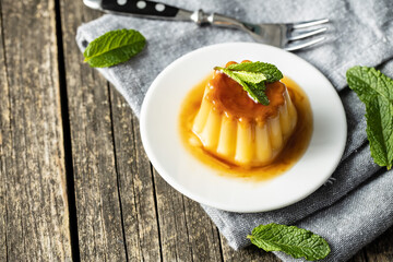 Sweet vanilla pudding. Sweet dessert with caramel topping.
