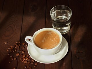 a cup of coffee and a glass of water on a wooden table .healthy eating concept