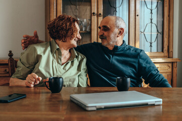 Senior couple relaxing at home and drinking coffee