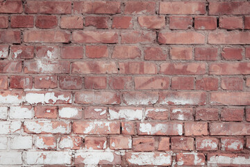 Non-linear pattern of an shabby brick wall with natural patterns of paint chips. Restoration of semi-antique brick walls. A basic neutral background for a design project.
