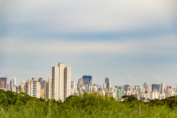 Fototapeta na wymiar Paisagem urbana da cidade de Goiânia com grama em primeiro plano.