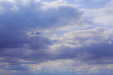 Cumulus clouds. Beautiful dark blue dramatic sky. Free space for lettering.