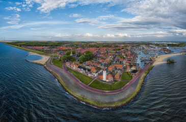 Fototapeta Panorama-aerial view of Urk with its lighthouse, a small coastal village on the IJsselmeer in the Netherlands.. obraz
