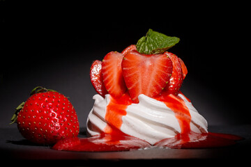 Individual Strawberry Pavlova with a strawberry coulis