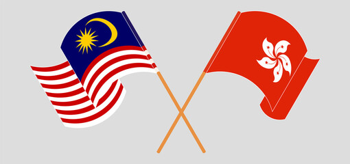 Crossed and waving flags of Malaysia and Hong Kong