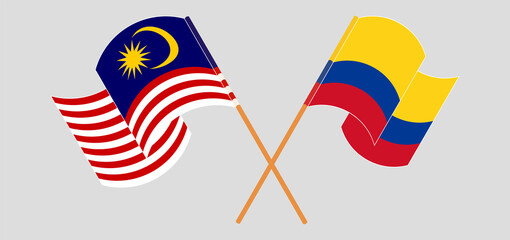 Crossed and waving flags of Malaysia and Colombia