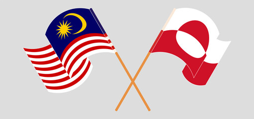 Crossed and waving flags of Malaysia and Greenland