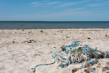 Fototapeta na wymiar Old nautical ropes left on the beach of the Baltic Sea. Selective focus. 