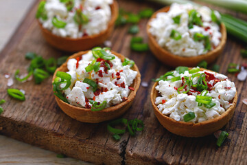 Selective focus. Macro. Tartlets with cottage cheese and herbs. Healthy snack. The keto diet.