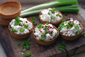 Selective focus. Macro. Tartlets with cottage cheese and herbs. Healthy snack. The keto diet.