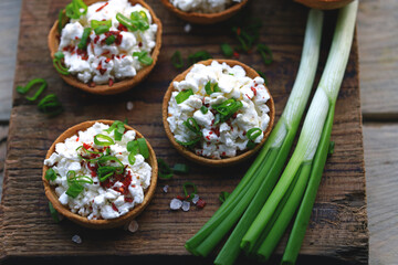 Selective focus. Macro. Tartlets with cottage cheese and herbs. Healthy snack. The keto diet.