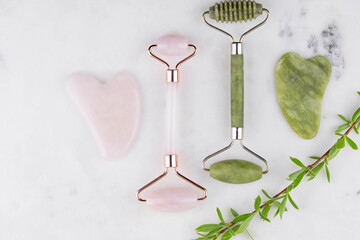 Face roller and guasha massager. Facial skin care and anti age products. Chinese Gua Sha massage tools from rose quartz and nephrite. 