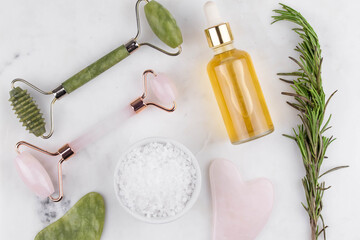 Face roller and guasha massager. Facial skin care, anti age products, sea salt and essential oil. Chinese Gua Sha massage tools from rose quartz and nephrite. 