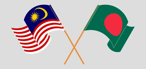 Crossed and waving flags of Malaysia and Bangladesh