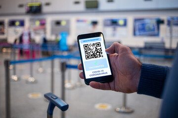health Vaccine Passport for Coronavirus or Covid-19. Traveller Using Mobile Phone with Vaccination in Immune Status to Certificated International Traveling in Airport
