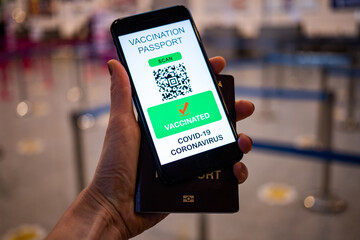 health Vaccine Passport for Coronavirus or Covid-19. Traveller Using Mobile Phone with Vaccination in Immune Status to Certificated International Traveling in Airport