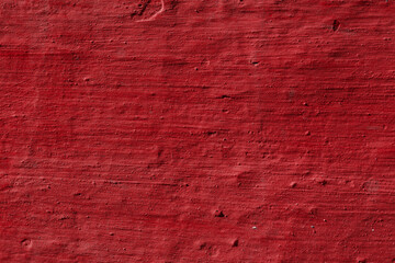 Texture of the red stucco wall with scratches, cracks, dust, crevices, roughness. Can be used as a poster or background for design.