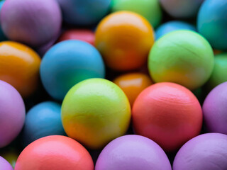 Background from multicolored bright small wooden balls of blue, yellow, red, lilac and green colors. A beautiful summer bright background for your projects.
