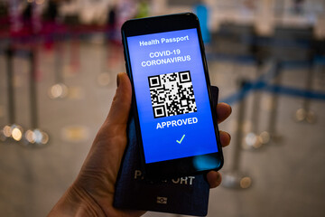health Vaccine Passport for Coronavirus or Covid-19. Traveller Using Mobile Phone with Vaccination in Immune Status to Certificated International Traveling in Airport