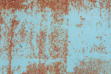 Blue metal texture with a rough surface. Traces of corrosion and elements of paint streaks and fading in the sun.