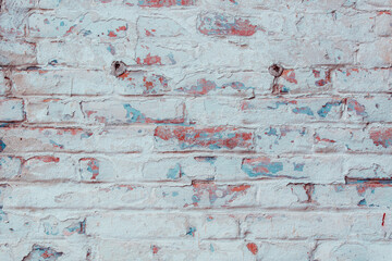 Texture of an old brick wall with shabby blue plaster. Natural damage to the paintwork. Natural aging concept.