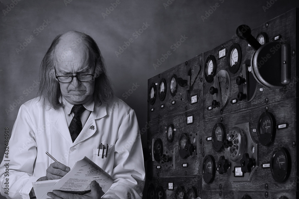 Wall mural Scientist working in its laboratory, doing a physics experiment, reading the user manual