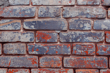 Old shabby wall with elements of destroyed bricks. Dark brick background. Can be used as background for design or poster.
