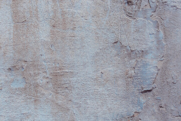 Grey concrete wall with natural defects. Fragment of the cement surface with natural texture. Monochrome palette of shades.