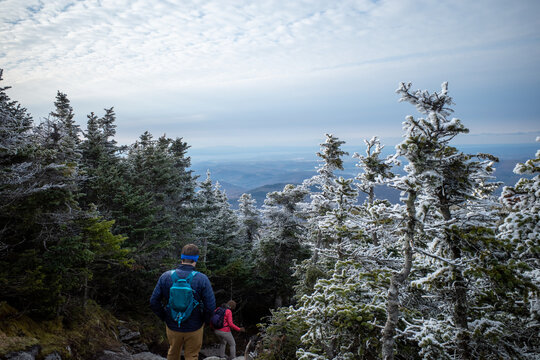 Two hikers navigate the Camel's Hump trail in Vermont after light snow