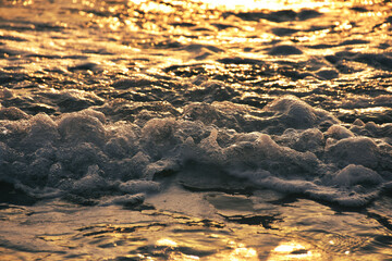  Sea waves crushing on shore. White sea foam. white foam waves in the wild sea at sunset.  white and blue foam waves in the wild sea at sunset.