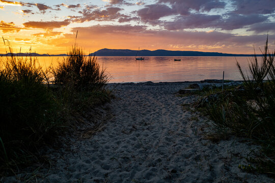 An epic sunset off the coast of the San Juan Islands, Washington State over sailboats