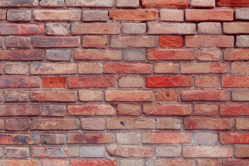 Old shabby wall with elements of destroyed bricks. Can be used as background for design or poster. Red brick background.