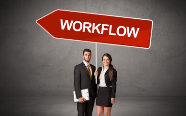 Young business person in casual holding road sign