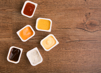 set of sauces on wooden background